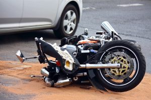 A motorcycle on its side due to collision in Seattle.