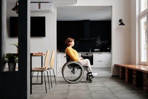 Injured woman sitting in her wheelchair while waiting for someone.