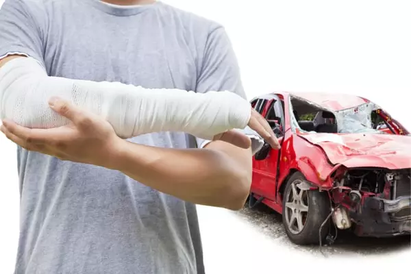 Closeup-Of-Bandaged-Arm-With-Red-Wrecked-Car